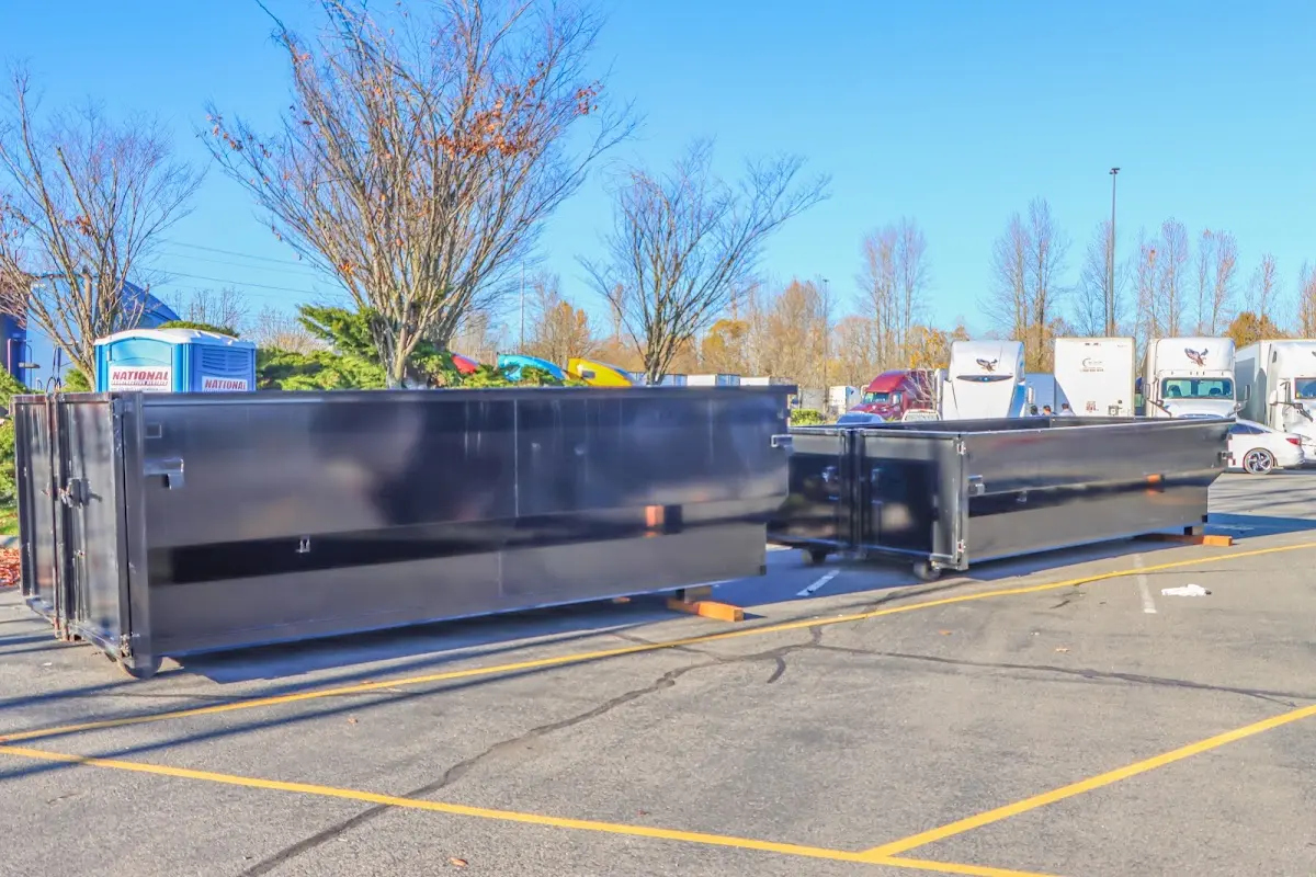 Professional dumpster rental service with roll-off container on residential driveway in Lake Goodwin